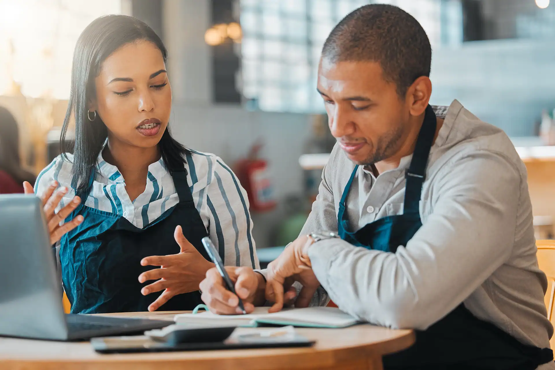 Employee & manager discussing form about employee & customer experiences.
